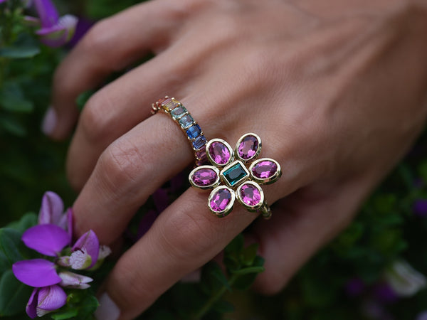 Hand showing pink tourmaline flower ring on index finger