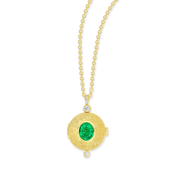 18k yellow gold locket necklace with diamond bail and bezel set white diamond. Center stone is an oval emerald and the is a bezel set white diamond at the bottom of the locket