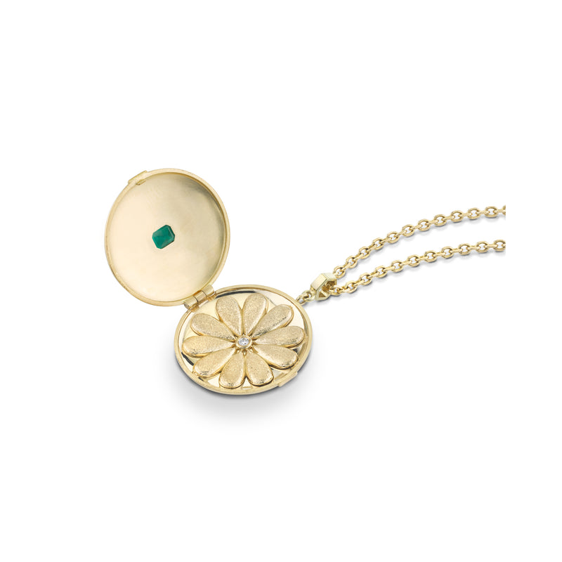 Inside of locket with gold flower shape and bezel diamond center stone
