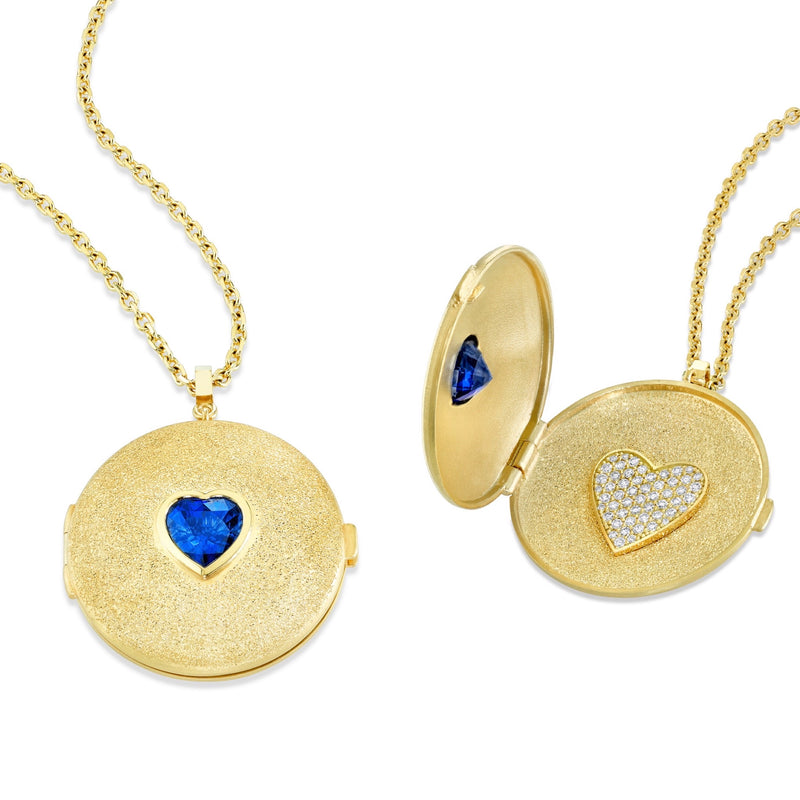 18k yellow gold locket necklace with bezel set heart shape center stone. Image of the locket open which shows white diamonds pavé set in the shape of a heart.