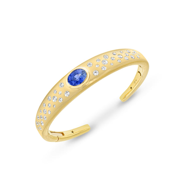 18k yellow gold cuff bracelet with an oval shaped blue opal center stone with scattered white diamonds