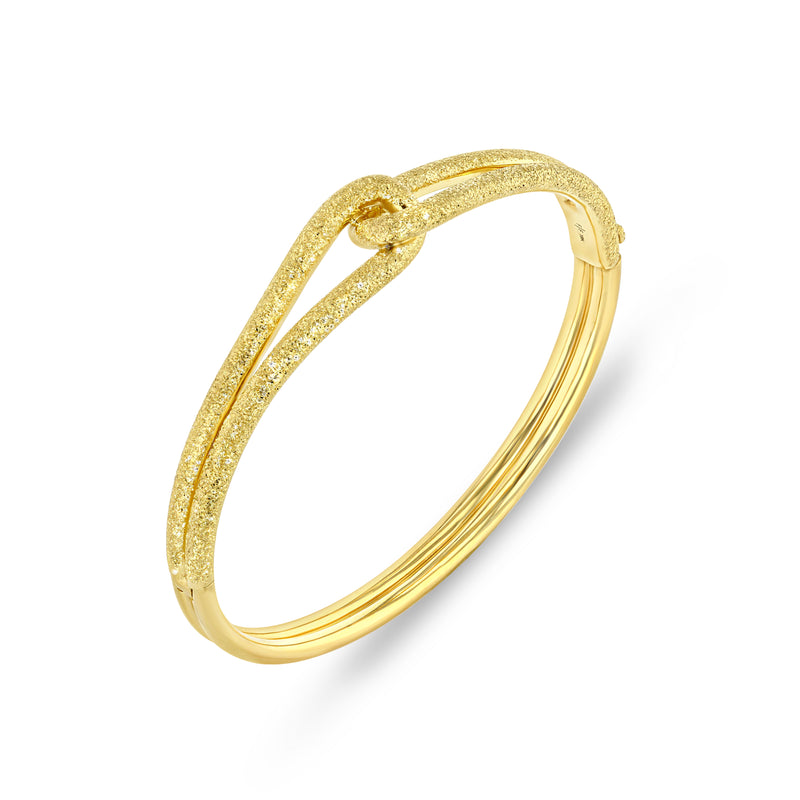 18k yellow gold hinged bangle with knot detail