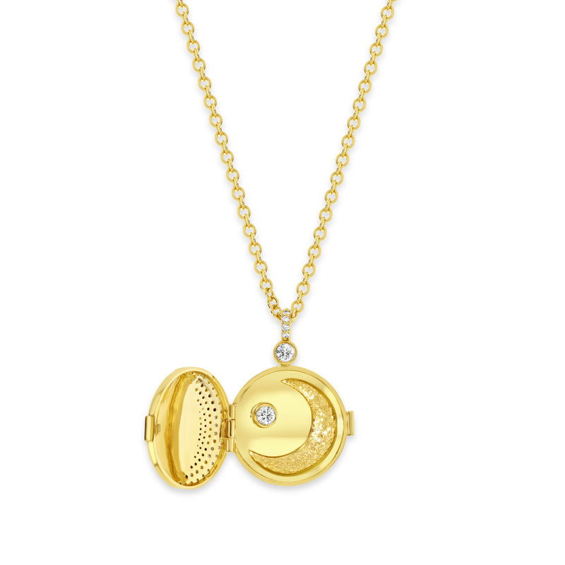 18k yellow gold inside of locket with gold crescent moon and bezel set white diamond