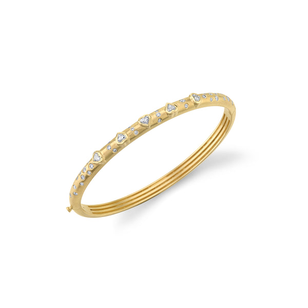 18k yellow gold hinged bangle with bezel set heart shaped white diamonds with scattered round white diamonds