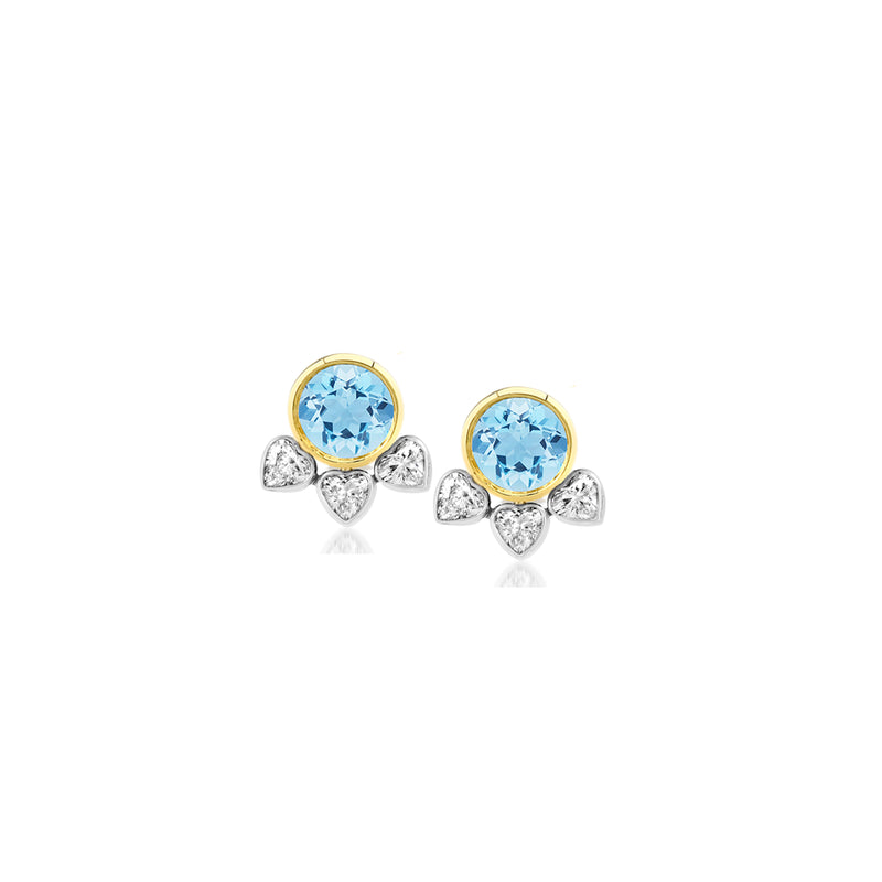 18k yellow gold stud earrings with heart shaped aquamarine center stone and 3 bezel set heart shaped diamonds in white gold attached below.