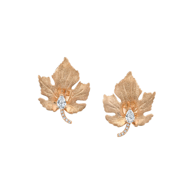 18k rose gold maple leaf shape stud earrings with pear shaped set diamond and pavé diamonds on the leaf stem