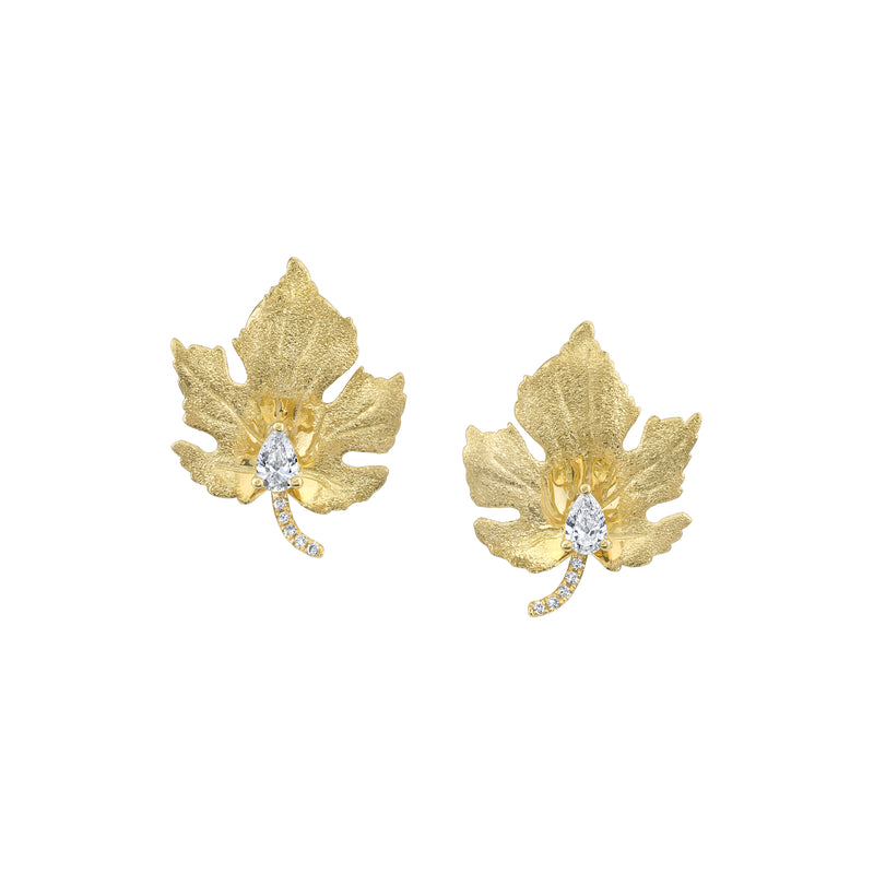 18k yellow gold maple leaf shape stud earings with pear shaped set diamond and pavé diamonds on the leaf stem